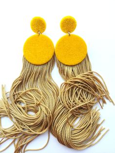 Elegant handmade earrings, golden yellow velvet earrings with golden high quality fringe. Stainless steel clasp on the back of the earring. Lenght: 14cm width: 3cm The earring color plays in the sun and changes from light to dark tones, which makes them one of a kind. If You are looking for large but lightweight earrings, then this is the right choice. The material used for the earring is surgical steel wich hopefully won't cause any allergies. Earrings come with a gift box. Made with love by No Yellow Fringe Jewelry For Party, Trendy Gold Tassel Earrings With Fringe, Yellow Fringe Tassel Earrings, Elegant Yellow Fringe Earrings, Yellow Dangle Tassel Earrings For Party, Yellow Fringe Tassel Drop Earrings, Elegant Yellow Dangle Tassel Earrings, Handmade Gold Tassel Earrings For Party, Gold Handmade Tassel Earrings For Party