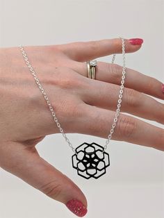 With a touch of silver and a splash of architectural lightness, this necklace with 3D printed geometric flower pendant adds just the right wink of uniqueness to any look! This pendant necklace is printed with TPU filament, a flexible plastic, and printed on an Anet AM8 3D printer. This lightweight piece weighs in at less than a quarter of an ounce, so nothing heavy to drag you down! Each pendant necklace is printed and assembled with care in Saratoga Springs, NY, and is ready to ship in 3-5 busi Modern Laser Cut Jewelry For Gifts, Laser Cut Metal Jewelry Gift, Elegant Laser Cut Jewelry As A Gift, Elegant Laser Cut Jewelry For Gifts, Elegant Laser Cut Jewelry Gift, Black Laser Cut Jewelry As Gift, Black Laser Cut Jewelry Gift, Geometric Black Necklace For Gift, Geometric Black Jewelry For Gifts