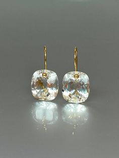 Gorgeous sparkly natural rock crystal drop earrings. The Faceted drops are flawless and sparkle like diamonds. The drops are attached to 24k gold vermeil ear wires. The earrings are elegant and have a lux look. A truly gorgeous pair of earrings. When 14K SOLID GOLD ear wires are being used, the ear wire ends are hand stamped as proof of being 14K solid gold. In addition, extra work was done at the end of the ear wires to prevent any sort of pain or injury while inserting them through the ear lob Cheap Hypoallergenic Crystal Earrings, Luxury Clear Earrings For Formal Events, White Topaz Drop Earrings For Wedding, Elegant Faceted Briolette Crystal Earrings, Elegant Briolette Faceted Crystal Earrings, Elegant White Faceted Crystal Earrings, Elegant Briolette Crystal Earrings, Dazzling Drop Crystal Earrings For Gifts, Diamond Drop Crystal Earrings For Gifts