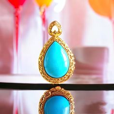 **Teardrop Turquoise Pendant** Its beautiful legend: ♥ A symbol of serene beauty. This pendant features a captivating teardrop-shaped turquoise gemstone, set in a lavishly detailed gold frame.  ♥ The vibrant hue of the turquoise, reminiscent of tropical waters, is perfectly complemented by the intricate scrollwork of the gold, which adds a touch of baroque elegance to the design.  ♥ The "Teardrop Turquoise Pendant" is a versatile piece that brings a hint of luxury and sophistication to any outfi Gold Cabochon Teardrop Pendant, Gold Cabochon Teardrop Pendant Jewelry, Turquoise Teardrop Pendant Jewelry As Gift, Blue Cabochon Drop Jewelry, Blue Drop Jewelry With Cabochon, Blue Drop Cabochon Jewelry, Turquoise Drop Jewelry Gift, Turquoise Drop Jewelry As A Gift, Elegant Turquoise Teardrop Pendant Jewelry