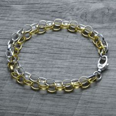 A layered mixed metal dual chain version of our classic sterling silver rolo link charm bracelet! One chain is yellow gold vermeil, and the other is sterling silver. The chains and closure are made in Italy, for an absolutely stunning piece. So shiny and classy! The double strand chain look amazing together and make a nice a statement. Finish on the yellow gold chain is 18k yellow gold vermeil and base material is 100% solid 925 sterling silver. The vermeil gold finish is 5 times thicker than re Metal Link Bracelets With Rolo Chain, Gold Metal Bracelets With Rolo Chain, Gold Charm Bracelet With Silver Chain, Gold Rolo Chain Link Bracelet, Gold Link Bracelets With Rolo Chain, Gold Link Bracelet With Rolo Chain, Rolo Chain Link Charm Bracelet As Gift, Gold Sterling Silver Cable Chain Bracelet, Gold Sterling Silver Bracelet With Cable Chain