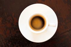 an overhead view of a cup of coffee on a saucer