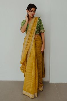 Mustard chanderi woven saree with dori hand embroidery. Comes with a blouse.
Components: 2
Pattern: Hand embroidered
Type Of Work: Dori
Neckline: Round
Sleeve Type: Half
Fabric: Chanderi
Color: Yellow
Other Details: 
Note : Outfit worn by the male model is not for sale.
Occasion: Sangeet - Aza Fashions Slub Silk Pre-draped Saree With Zari Work For Puja, Navratri Pre-draped Saree With Cutdana, Yellow Handloom Pre-draped Saree For Wedding, Bollywood Style Pre-draped Saree In Raw Silk, Semi-stitched Cotton Silk Pre-draped Saree With Zari Work, Festive Chanderi Pre-draped Saree, Chanderi Pre-draped Saree For Festive Occasions, Eid Cutdana Pre-draped Saree For Puja, Pre-draped Saree With Dupatta For Puja