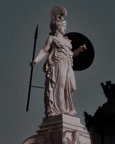 a statue on top of a building with a clock