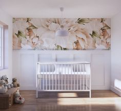 a baby's room with a crib and flowers on the wall