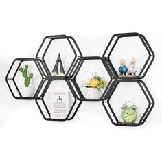 the hexagonal shelves have pictures on them and are hanging from the wall,