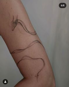 a woman's arm with a tattoo design on the left side of her body