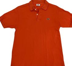 Get your street style on with this vintage Lacoste orange polo t-shirt! Unleash the vibrant spirit of authentic Lacoste fashion in bold, bright orange. Elevate your look and turn heads wherever you go  it's more than just a shirt, it's a statement!  TAG READS: Lacoste, size 4, Devenlay, Made in France, 100% Cotton Keep in mind vintage tag sizes vary from modern day sizing. MEASUREMENTS   (Taken in inches lying flat are approximately) LENGTH: 27 inches Measure from top to bottom. SHOULDERS: 18 inches Measure from shoulder to shoulder. CHEST:  20 inches Measure from arm pit to arm pit. BOTTOM WAIST: 21 inches Measure across bottom of garment. SLEEVE LENGTH: 14 inches Measure from neck to wrist. ARM CUFF: 5 inches Measure cuff width. Compare measurements to those of a similar garment you alre Summer Orange Polo Shirt With Polo Collar, Orange Polo Shirt With Polo Collar For Summer, Orange Polo Shirt With Collar For Summer, Summer Orange Polo Shirt With Collar, Orange Cotton Polo Shirt For Summer, Summer Orange Cotton Polo Shirt, Classic Orange Collared Top, Casual Orange Collared T-shirt, Classic Orange Cotton Tops