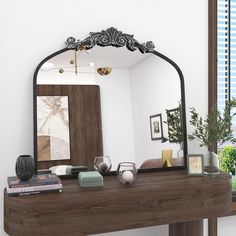 a mirror sitting on top of a wooden table