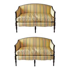 a set of two striped couches sitting side by side on top of each other