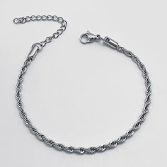 Crafted with meticulous attention to detail, this bracelet features a mesmerizing twisted chain design, adding a touch of glamour to any outfit. Whether you're dressing up for a special occasion or adding a chic accent to your everyday look, our bracelet is the perfect choice. Available in silver and gold Elegant Stainless Steel Braided Bracelet, Elegant Bracelets With Rope Chain And Link Shape, Elegant Bracelets With Rope Chain Link, Elegant Bracelets With Link Rope Chain, Elegant Rope Chain Link Bracelets, Elegant Rope Chain Link Bracelet, Twisted Chain, Mini Twists, Silver Chain Bracelet