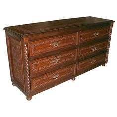 a wooden dresser with ornate carvings on the top and bottom, along with an advertise