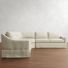 a white couch sitting on top of a hard wood floor next to a wooden floor