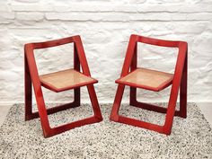 two red chairs sitting next to each other