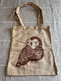 "Made To Order Owl Block Print Tote Bag Hand carved and made by me, each tote bag is unique and may vary. Each tote bag is made to order. Don't see a certain color you like? Just ask! I will be more than happy to work with you. MEASUREMENTS: Approximately 13\"x11\"  Thanks for visiting! If you have any questions, comments or are interested in commissions please don't hesitate to reach out. Follow @thesmilingoctopus on instagram!" Brown Canvas Tote Bag For Gifting, Brown Canvas Tote Bag For Gift, Brown Tote Canvas Bag For Gift, Eco-friendly Tote Bag For Crafting, Hand Printed Canvas Tote Bag - Ideal Gift, Hand Printed Canvas Tote Bag Perfect For Gifts, Hand Printed Canvas Tote Bag For Gift, Hand Printed Canvas Tote Bag Ideal For Gifts, Hand-printed Tote Bag For Daily Use