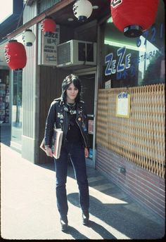 a woman standing in front of a store