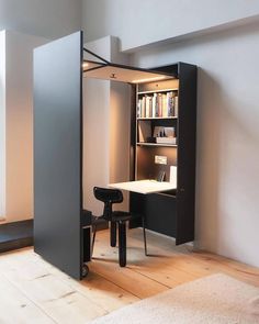 a room with a desk, chair and bookcase in it's open door