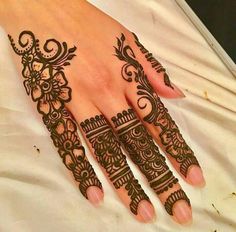 a woman's hand with henna tattoos on it