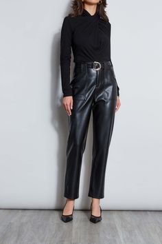 Our Straight Leg Vegan Leather Pant features a mid-rise silhouette, pockets & front zip closure. Designed with a chic metal D-ring buckle, this pant will quickly become a staple in your wardrobe. Vegan Leather Belted Ankle Pant 100% Polyester Runs True to size Model is 5'9" and wearing a size 4 100% Polyurethane Imported Style #: ETR44227 Vegan Leather Pant, Leather Pant, Jumpsuit Jacket, Belted Pants, Long Sleeve Short Dress, Knit Tees, Denim Coat, Knit Jacket, Cardigan Jacket