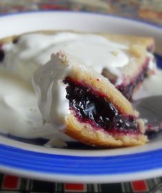 a blueberry pie with white icing on a plate