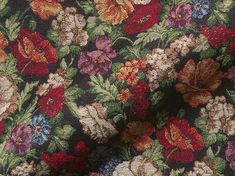 a close up view of a flowered fabric with many colors and sizes on it