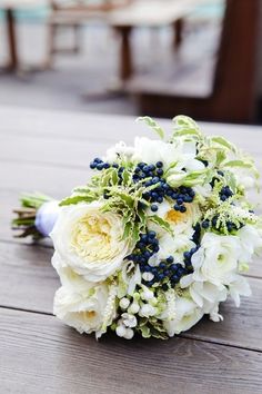 a bridal bouquet sitting on top of a wooden table