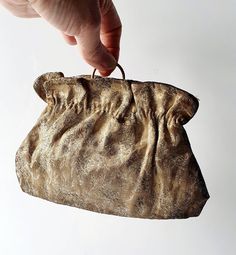 a hand is holding an old purse on a white background