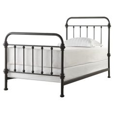 a metal bed frame with white sheets and pillows on the bottom, in an ad for target com