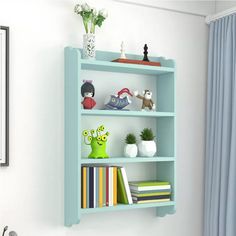 a blue book shelf with books and vases on it