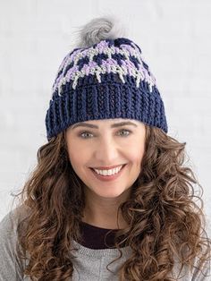 a smiling woman wearing a knitted hat