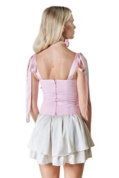 The Elsa bustier boasts a harmonious blend of timeless elements and contemporary details. With its long shoulder ties, it offers versatility in styling, allowing you to create your own unique look. The structured bodice provides a flattering silhouette, accentuating your curves with grace and poise. The ruched bust adds a touch of allure, while the back zipper ensures a secure and seamless fit. Elegant Party Corset With Adjustable Straps, Elegant Corset With Adjustable Straps For Party, Evening Fitted Crop Top With Boned Bodice, Elegant Overbust Crop Top For Party, Elegant Underbust Crop Top For Parties, Chic Corset With Boned Bodice And Fitted Top, Spring Fitted Boned Bodice Corset, Elegant Summer Backless Corset, Elegant Backless Summer Corset