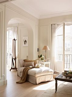 a living room filled with furniture and lots of windows