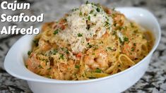 a white bowl filled with pasta and shrimp