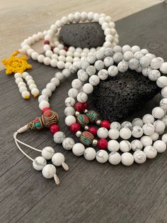 Beautiful Howlite Mala from Nepal and Mountain shell beads Mala necklace. You can choose between the mala that is made with howlite beads (white with gray) and mix metal beads from Nepal, or the all white mala necklace, which is made with mountain shell beads and a yellow mantra symbol. A unique praying mala that can be used as a necklace or as an ornament. The mala has no clasp, you wear it over the head. --The Mala with the metal beads and the red beads has a total length of 48.2cm- 19 inch lo White Adjustable Mala With Gemstone Beads, Adjustable White Mala With Gemstone Beads, Adjustable White Gemstone Beads Mala, Adjustable White Mala With 8mm Beads, White Gemstone Beaded Necklaces For Meditation, White Beaded Necklaces With Gemstone Beads For Healing, White Spiritual Necklace With Polished Beads, Healing White Gemstone Beaded Necklaces, White 8mm Beaded Bohemian Necklaces