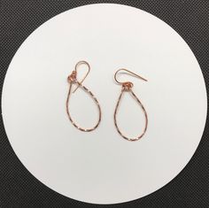 Shiny, lightweight twisted copper teardrop earrings.Approximately 1 1/2" long and 7/8" wideThese earrings have been polished and sealed. Sealed with Protectaclear ProtectaClear is a clear, protective coating that is tough enough to protect jewelry and is safe for wear against skin. ProtectaClear is practically invisible once applied and will seal and protect jewelry from tarnish, oxidation, and corrosion Silver Teardrop Jewelry With Copper Wire, Silver Teardrop Jewelry In Copper Wire, Elegant Teardrop Copper Wire Earrings, Copper Wire Teardrop Earrings, Copper Teardrop Hoop Earrings With Ear Wire, Teardrop Wire Wrapped Earrings, Rose Gold Hammered Teardrop Jewelry, Teardrop Copper Hoop Earrings For Pierced Ears, Wire Wrapped Copper Teardrop Earrings