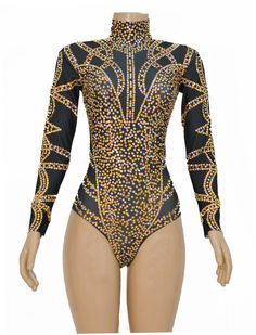 a mannequin wearing a bodysuit with gold and black designs