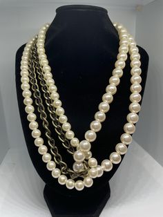 Asymmetrical faux pearl beaded necklace. Two pearl strands and one chain strand with small chain running through it. Larger pearl strand comes down one side and wraps through the other strands, creating and interesting, asymmetrical look. In good vintage condition, minimal wear. Pearl White Beaded Pearl Chain Necklace, Party Pearl Beaded Chain Necklace, Multi-strand Pearl Chain Beaded Necklaces For Party, Round Beaded Pearl Chain Necklace For Parties, Party Pearl Chain Necklace With Round Beads, Long Pearl Necklace With Chain, Pearl Chain Necklace For Party, Double Strand Pearl Chain Necklace For Party, Pearl White Chain Pearl Necklace For Party