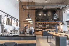 the interior of a coffee shop with tables and chairs