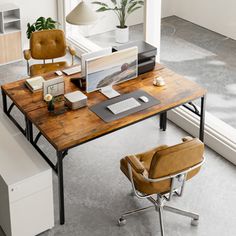 an office desk with a computer on it and a chair next to it in front of a window