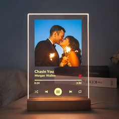 an illuminated photo frame with a couple kissing and holding sparklers in front of them