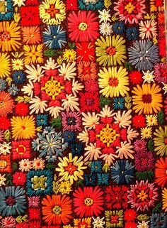 an old quilt with colorful flowers on it