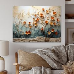 a living room scene with focus on the couch and wall art that has flowers painted on it