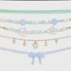 Accessorize your little one's outfit delightfully with the Girls' 5pk Blue Beaded Bow Choker Necklace Set from Cat & Jack™. Each choker measures 11 inches in length and features a secure lobster claw clasp for a secure and comfy fit. Made from durable polyester, acrylic and recycled iron, these necklaces are both stylish and sturdy, making them a great addition to your little fashionista's accessory collection. Cat & Jack™: Designed for all children so you can trust it's made for yours. Cute Preppy Beaded Necklaces, Coquette Diy, Tattoo Choker Necklace, Bow Choker, Beaded Bow, Charm Choker Necklace, Making Bracelets, Bow Bracelet, Choker Necklace Set