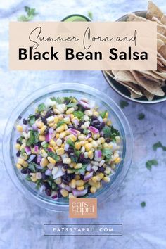 a bowl filled with corn and black bean salsa next to a bowl of tortilla chips