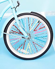 a blue bicycle with multicolored spokes on the front wheel