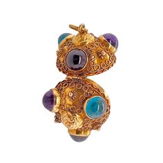 This is part of Chairish’s Fine Jewelry assortment.  This is a wonderful 18K gold Victorian Etruscan Revival multi-gem locket/pendant. There are a total of six bezel-set cabochon stones, two amethysts, two garnets, and two blue tourmalines. The piece has applied Etruscan beadwork. It is hinged and opens at the center. There are no marks, but it tests 18K. The condition is excellent.  Dimensions: Diameter from stone to stone: 1 1/4", Weight: 12.5 grams Yellow Gold Multi-stone Cabochons For Fine Jewelry, Yellow Gold Multi-stone Cabochons Fine Jewelry, Fine Jewelry Multi-stone Cabochons As Gift, Gold Multi-stone Gemstones, Unique Multi-stone Gold Gemstones, Yellow Gold Multi-stone Cabochons For Gift, Luxury Yellow Gold Gemstone Cabochon, Gold Gemstone Round Beads, Gems And Cabochons, Gold Gemstone Beads And Cabochons