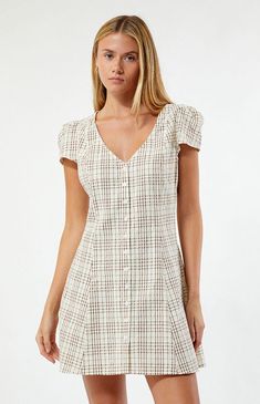 Introducing the Rumi Check Cap Sleeve Mini Dress from Rhythm, crafted from 100% cotton textured fabric with a yarn-dyed check print. This button-down dress boasts a relaxed fit, complemented by an adjustable back tie, a V neckline, and cap sleeves, offering a blend of comfort, casual style, and elegant charm.UnlinedShort cap sleevesV-necklineButton-down front closureBack tieRelaxed fit100% CottonModel is wearing a size smallModel measurements: 5’8” height, 31” bust, 23” waist, 36” hips Rhythm Womens Rumi Check Cap Sleeve Mini Dress - Natural size XS Chefs Kiss, Cotton Texture, Fall Fits, 70 Dress, Button Down Dress, Textured Fabric, Mini Dress With Sleeves, Dress Romper, Pacsun