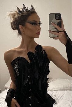 a woman is taking a selfie with her cell phone wearing a black corset