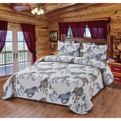 a bed in a room with wooden floors and curtains on the windowsill, along with a horse themed comforter