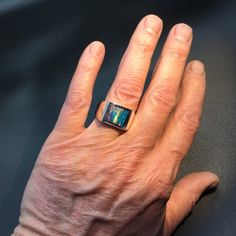 This is our own spin on a timeless classic. We've channel inlaid kyocera opal into our extra heavy mounting (approx. 19 grams). We softened the square just slightly and domed it a bit which gives it a classy look and feel.I like to think of my pieces as heirloom quality, built to last a lifetime.Stone:Lab-Created Kyocera Opal.I also make this ring on other stones:Black Onyx http://www.etsy.com/listing/61398623/mens-heavy-custom-square-black-onyx-ring Lapis http://www.etsy.com/listing/61398979/me Modern Formal Cabochon Opal Ring, Formal Modern Opal Cabochon Ring, Modern Formal Opal Ring With Cabochon, Modern Formal Opal Jewelry, Modern Gold Opal Ring With Polished Finish, Modern Collectible Rectangular Jewelry, Modern Opal Ring For Anniversary, Modern Opal Jewelry For Anniversary, Blue Star Sapphire